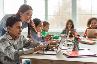 A picture of a teacher helping students