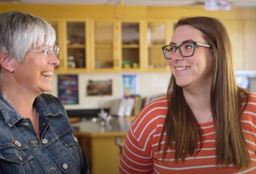 Two teachers talking and smiling